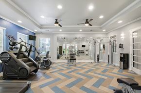 Fairfield apartment for rent - A spacious gym with a variety of equipment and a patterned carpet.