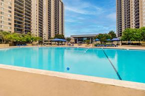 Falls Church apartment for rent - A large swimming pool in front of apartment buildings.