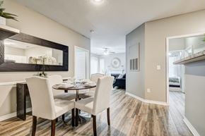 Franklin apartment for rent - A dining room with a table set for two and a mirror on the wall.
