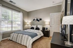 Franklin apartment for rent - A bedroom with a bed, nightstands, and a window with blinds.