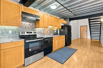 San Francisco apartment for rent - A kitchen with wooden cabinets and a black refrigerator.