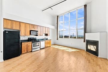 San Francisco apartment for rent - A kitchen with black appliances and wooden cabinets.