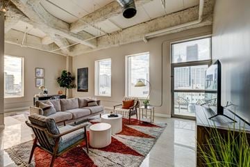 Los Angeles apartment for rent - A living room with a grey couch and a red rug.