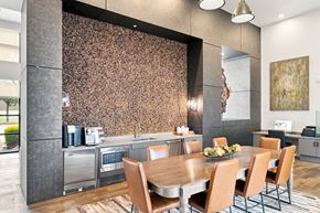Dallas apartment for rent - A modern kitchen with a wooden table and chairs.