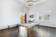 Walnut Creek apartment for rent - A pool table in a room with wood flooring and white walls.