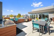 Walnut Creek apartment for rent - A patio with a table and chairs is surrounded by buildings.