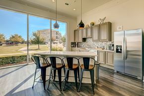 Aubrey apartment for rent - A kitchen with a table and chairs in front of a window.