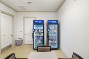 Wylie apartment for rent - A room with a table, chairs and two vending machines.