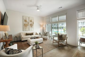 Birmingham apartment for rent - A living room with a white couch, a chair, a coffee table, and a painting on the wall.