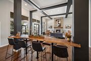Littleton apartment for rent - A modern dining room with a long wooden table and chairs.