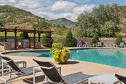 Littleton apartment for rent - A pool surrounded by chairs and a mountain in the background.