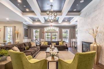 Westborough apartment for rent - A living room with a grey couch and green chairs.