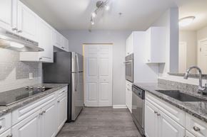 Westborough apartment for rent - A kitchen with white cabinets and a black refrigerator.