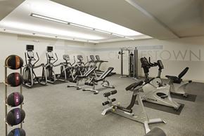 Charlestown apartment for rent - A gym with a variety of exercise equipment including treadmills, stationary bikes, and weight machines.