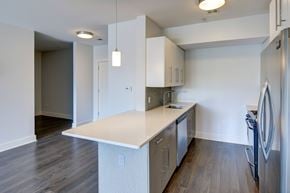Charlestown apartment for rent - A kitchen with a white counter top and stainless steel appliances.