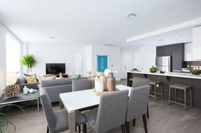 San Jose apartment for rent - A modern dining room with a white table and grey chairs.