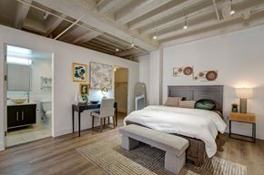 Los Angeles apartment for rent - A bedroom with a large bed and a desk with a chair.