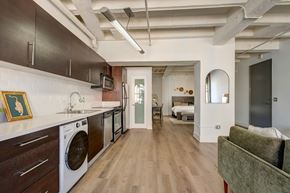 Los Angeles apartment for rent - A modern kitchen with dark wood cabinets and a green couch.