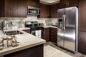 Los Angeles apartment for rent - A modern kitchen with a stainless steel refrigerator and wooden cabinets.