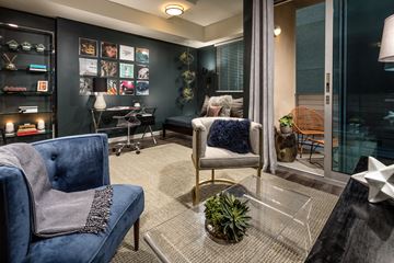 Los Angeles apartment for rent - A blue chair with a blanket on it sits in a living room.