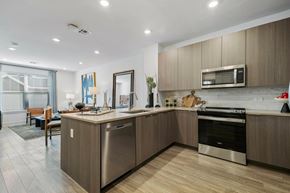 Plymouth apartment for rent - A modern kitchen with wooden cabinets and stainless steel appliances.