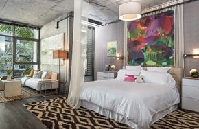 Los Angeles apartment for rent - A bedroom with a large bed and a painting on the wall.