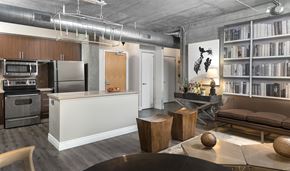Los Angeles apartment for rent - A modern kitchen with a white island and a dining table with chairs.