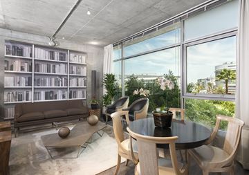 Los Angeles apartment for rent - A modern living room with a glass table and chairs, a sofa, and a bookshelf.