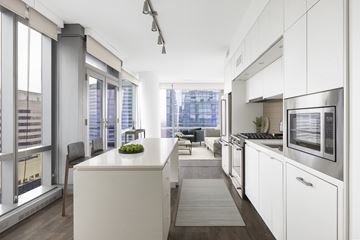 Arlington apartment for rent - A modern kitchen with white cabinets and a large island.