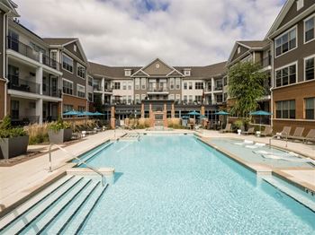 Resort-style pool with a hot tub and sun shelf
