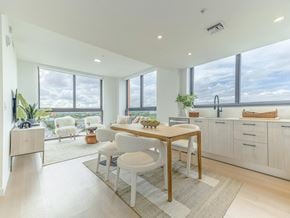 Miami apartment for rent - a kitchen and dining area with a table and chairs and large windows
