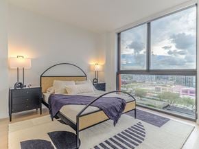 Miami apartment for rent - 29 Wyn a bedroom with a bed and a large window with a city view