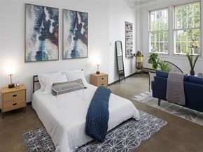 Portland apartment for rent - A bedroom with a large bed and two paintings on the wall.