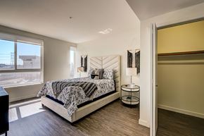 Los Angeles apartment for rent - A bedroom with a large bed and a view of the outside.