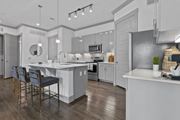 San Antonio apartment for rent - A modern kitchen with a dining table and chairs.