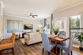 Round Rock apartment for rent - A dining room with a wooden table and grey chairs.