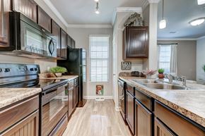 San Antonio apartment for rent - A kitchen with wooden cabinets and a granite countertop.