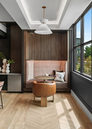 Old Tappan apartment for rent - A modern living room with a brown sofa and a round wooden table.
