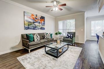 Houston apartment for rent - A living room with a grey couch, a coffee table, and a painting on the wall.