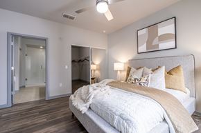 Heathrow apartment for rent - A bedroom with a large bed and a mirror on the wall.