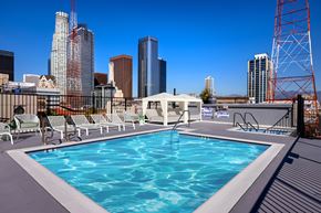 Los Angeles apartment for rent - A pool on a rooftop with a city skyline in the background.