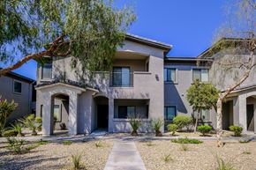Las Vegas apartment for rent - A modern house with a grey exterior and a gravel driveway.