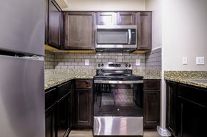 Las Vegas apartment for rent - A kitchen with a stainless steel refrigerator and a stainless steel oven.