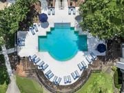 Columbus apartment for rent - An aerial view of a swimming pool surrounded by lounge chairs and trees.