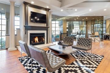 Columbus apartment for rent - A living room with a fireplace and a television mounted above it.