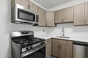Falls Church apartment for rent - A modern kitchen with a stainless steel oven and microwave.