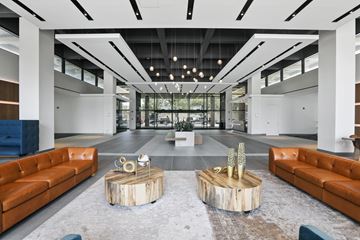 Falls Church apartment for rent - A modern living room with a wooden coffee table in the center.