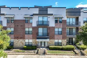 Mckinney apartment for rent - A multi-story apartment building with brick and stone exteriors and balconies.