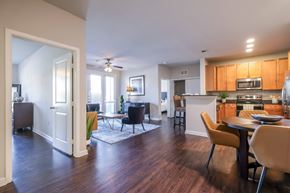 Mckinney apartment for rent - A modern kitchen with a dining table and chairs.