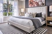Jupiter apartment for rent - A bedroom with a large bed and a painting on the wall.